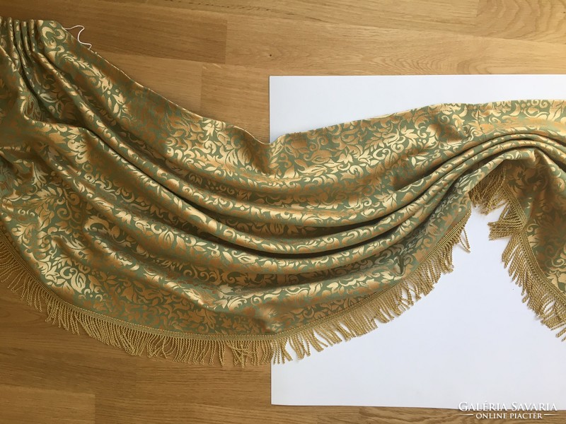 Drapery made of green-gold brocade with gold fringe