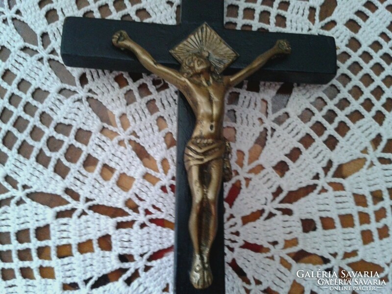 Old wooden cross in black with copper jesus pictures