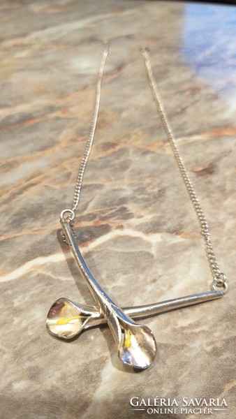 Collector's item: individually designed silver necklace marked with calla