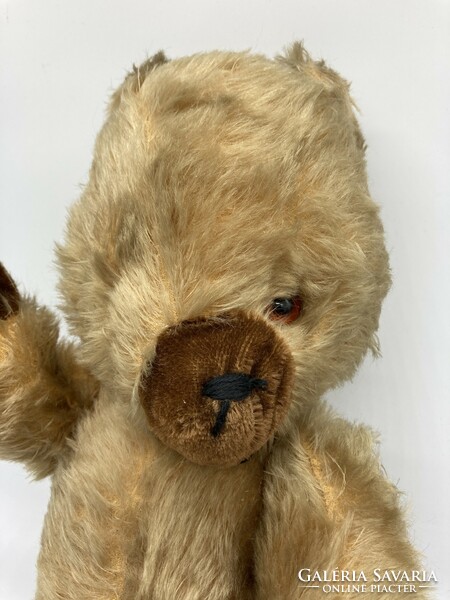 Old long-furred toy teddy bear with movable arms