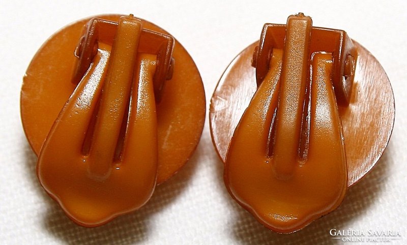 Pair of vintage vinyl records with amber earplugs