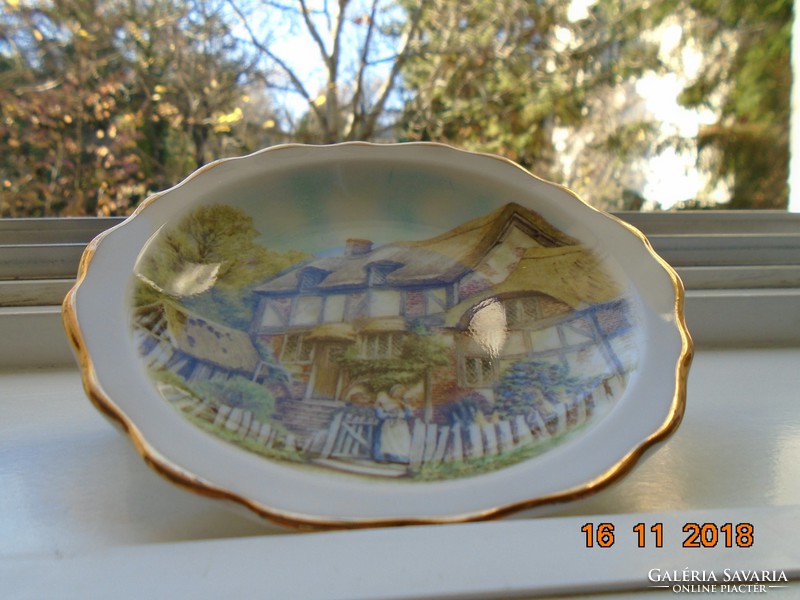 Decorative small plate with a Victorian village image from the 