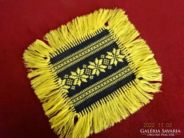 Embroidered black placemat with yellow fringe and embroidery. He has! Jokai.