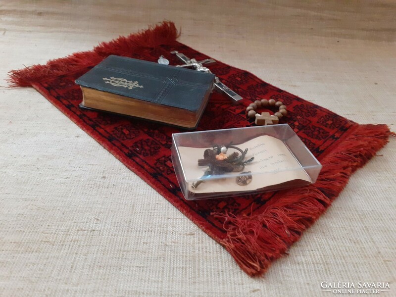 Old German Christian heirloom prayer book in a box with mother-of-pearl rosary with relics on a small tablecloth