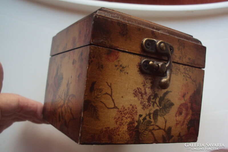 Small vintage wooden jewelry box in the style of a pirate chest, brown velvet lining, aged lock.