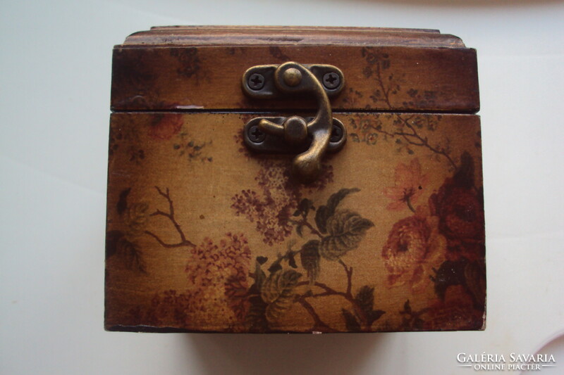 Small vintage wooden jewelry box in the style of a pirate chest, brown velvet lining, aged lock.