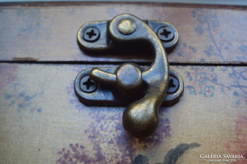 Small vintage wooden jewelry box in the style of a pirate chest, brown velvet lining, aged lock.