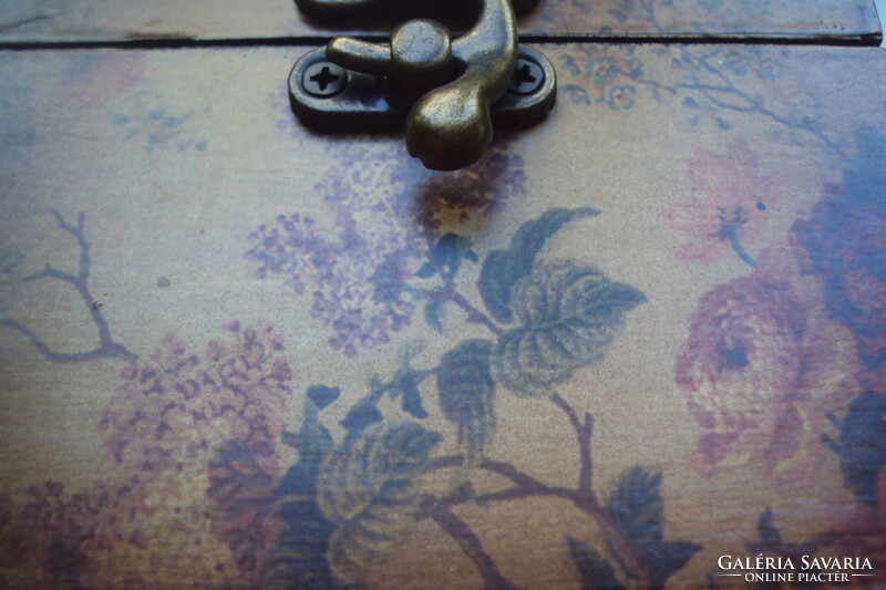 Small vintage wooden jewelry box in the style of a pirate chest, brown velvet lining, aged lock.