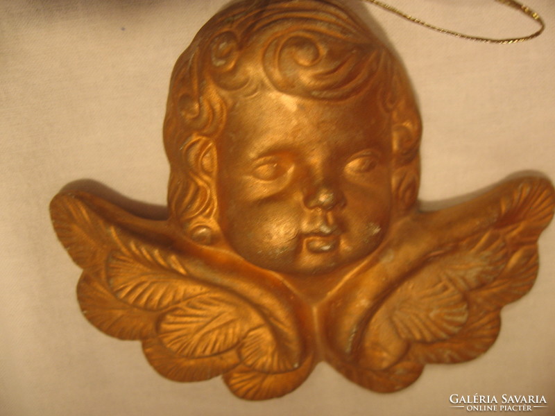Gilded putto head with Christmas tree ornament