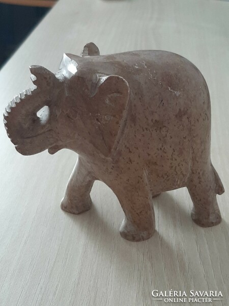 A luck-bringing elephant with a raised trunk carved from grease stone