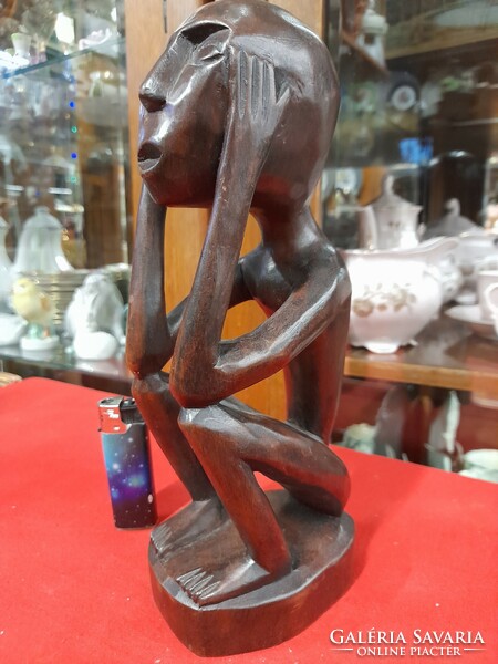 Hand-carved solid wood figural sculpture.