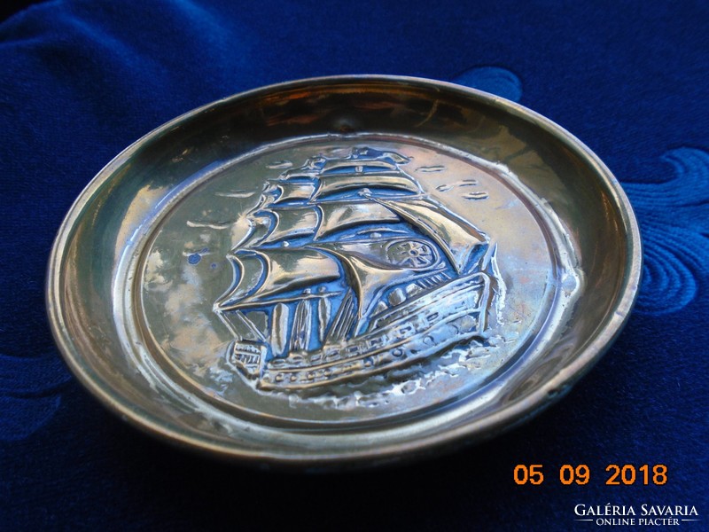 Small copper decorative plate with a convex sailing ship