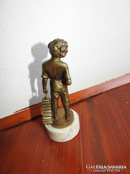 Shoeing little boy - bronze statue on a marble base