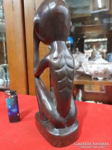 Hand-carved solid wood figural sculpture.