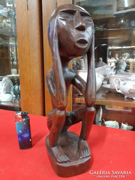 Hand-carved solid wood figural sculpture.