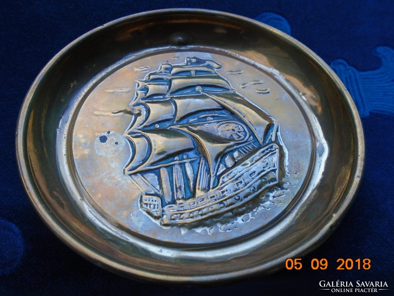 Small copper decorative plate with a convex sailing ship