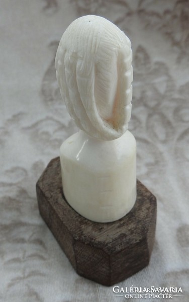 Antique oriental bone sculpture on wooden pedestal