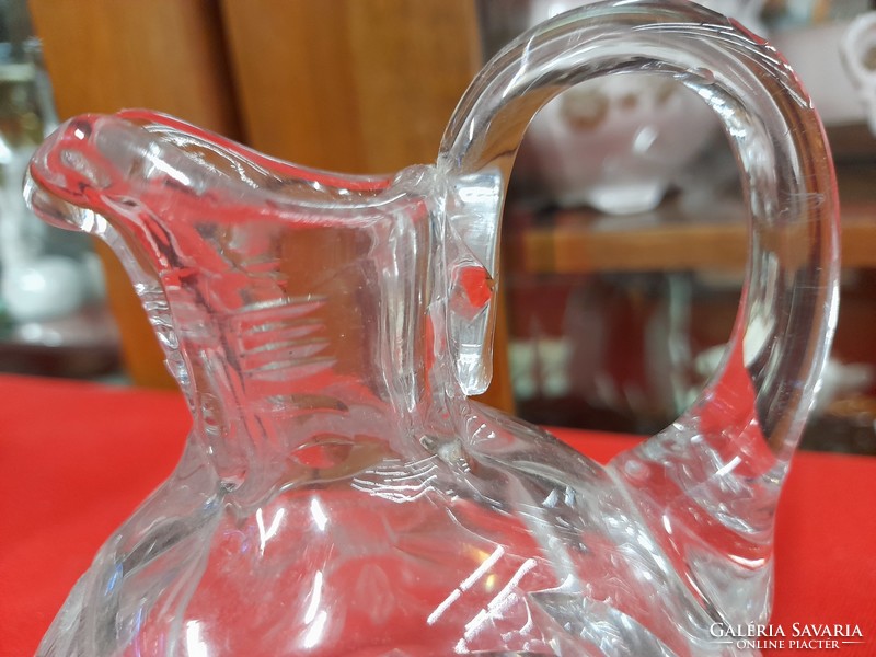 Polished thick glass jug with spout.
