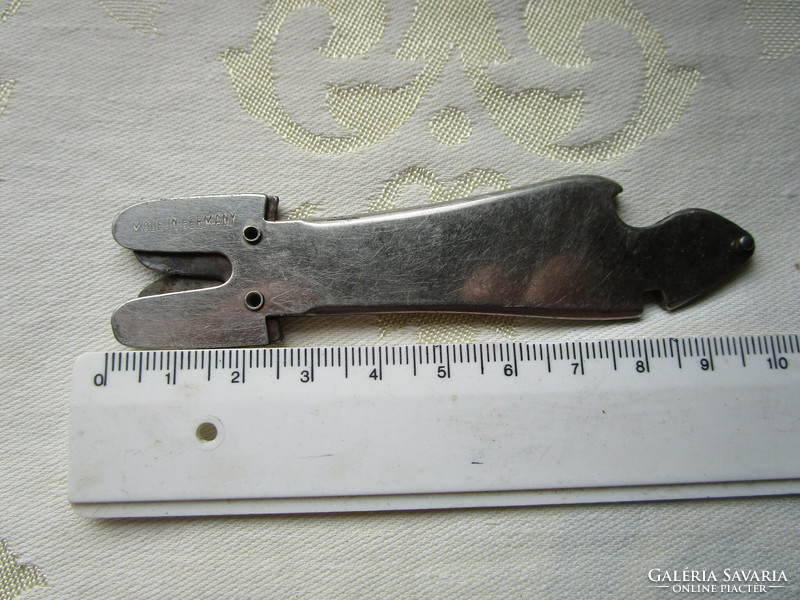 Antique iron knife sharpener and beer opener