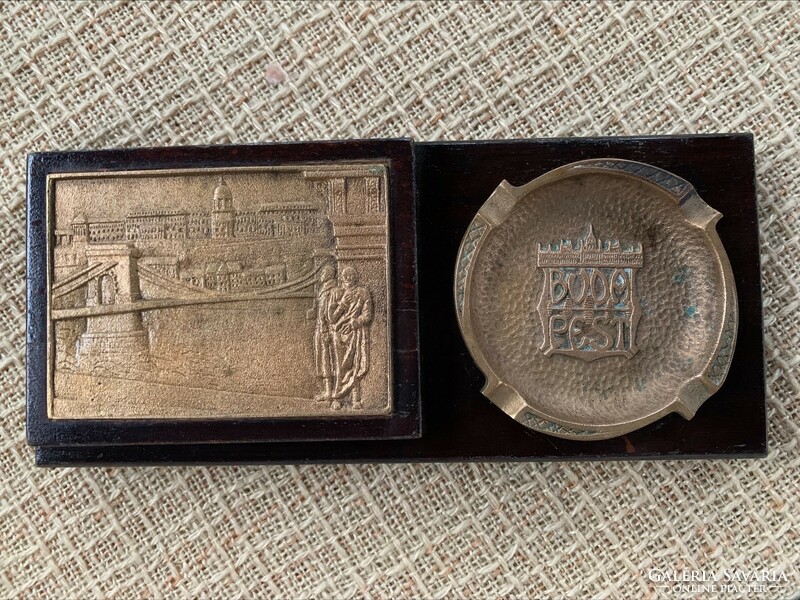 Cigarette holder with copper chain bridge plaque and copper ashtray with Budapest inscription in a wooden house