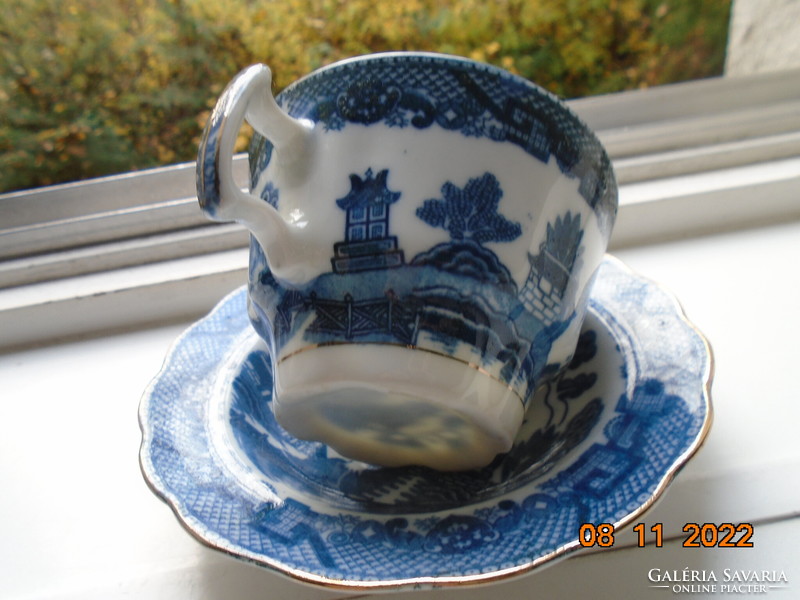 Cobalt blue painted oriental willow pattern English teacup with saucer