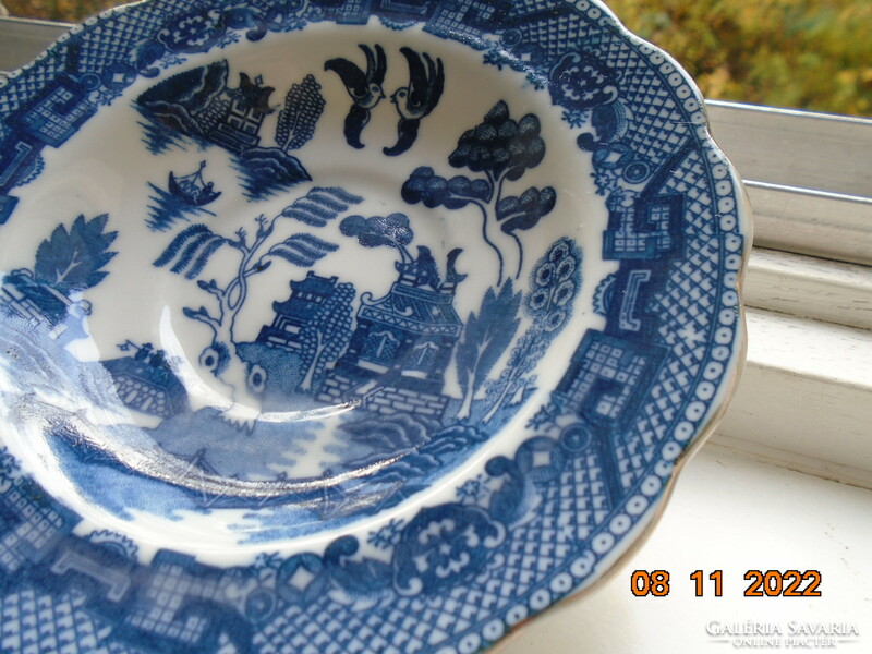 Cobalt blue painted oriental willow pattern English teacup with saucer