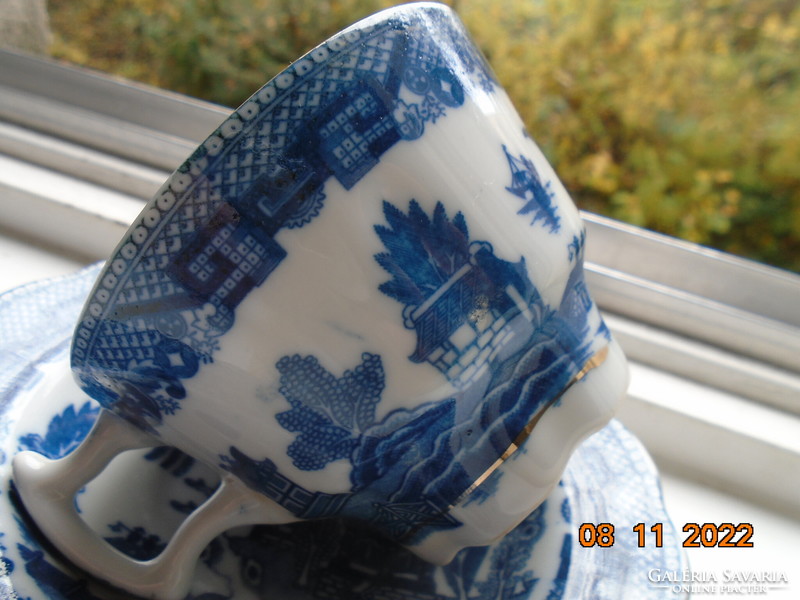 Cobalt blue painted oriental willow pattern English teacup with saucer