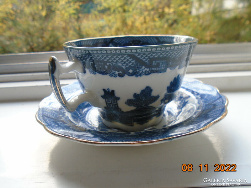Cobalt blue painted oriental willow pattern English teacup with saucer