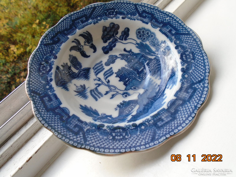 Cobalt blue painted oriental willow pattern English teacup with saucer