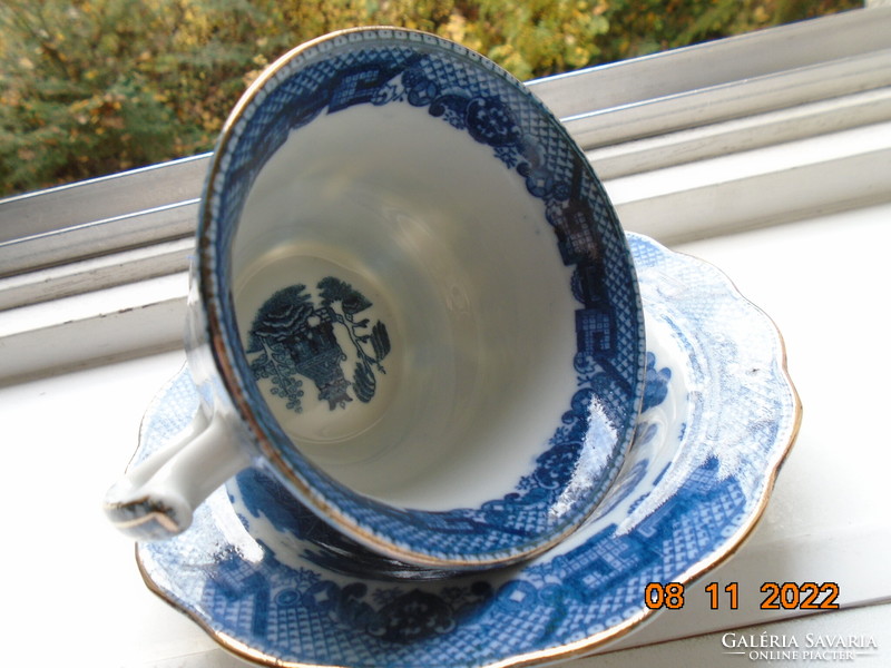 Cobalt blue painted oriental willow pattern English teacup with saucer