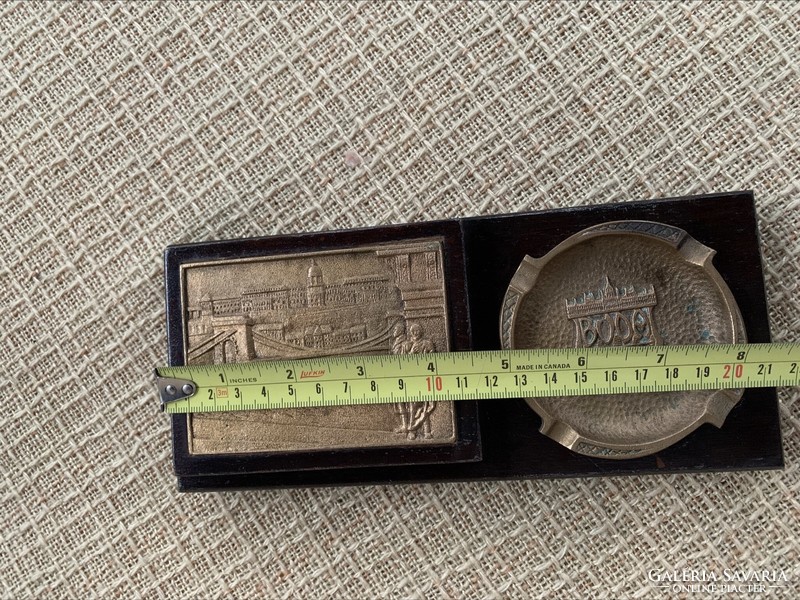 Cigarette holder with copper chain bridge plaque and copper ashtray with Budapest inscription in a wooden house