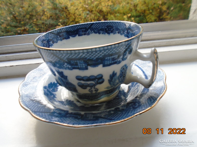 Cobalt blue painted oriental willow pattern English teacup with saucer