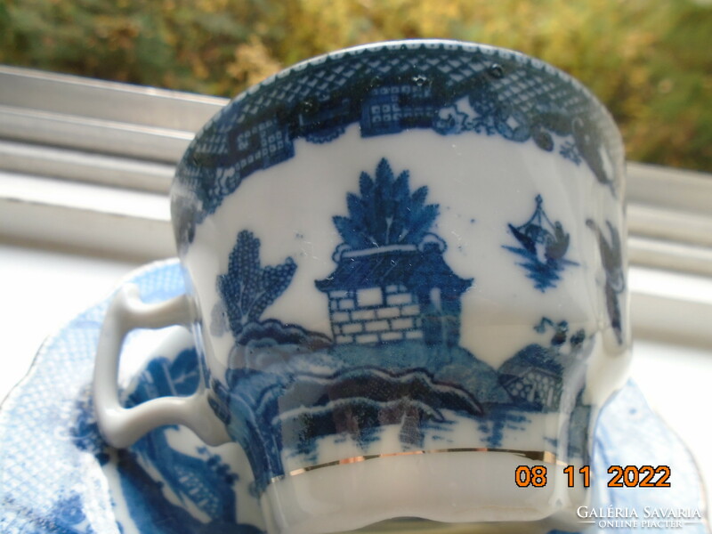 Cobalt blue painted oriental willow pattern English teacup with saucer