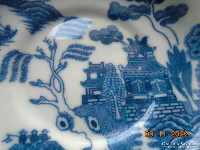 Cobalt blue painted oriental willow pattern English teacup with saucer