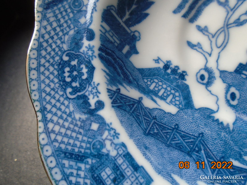 Cobalt blue painted oriental willow pattern English teacup with saucer