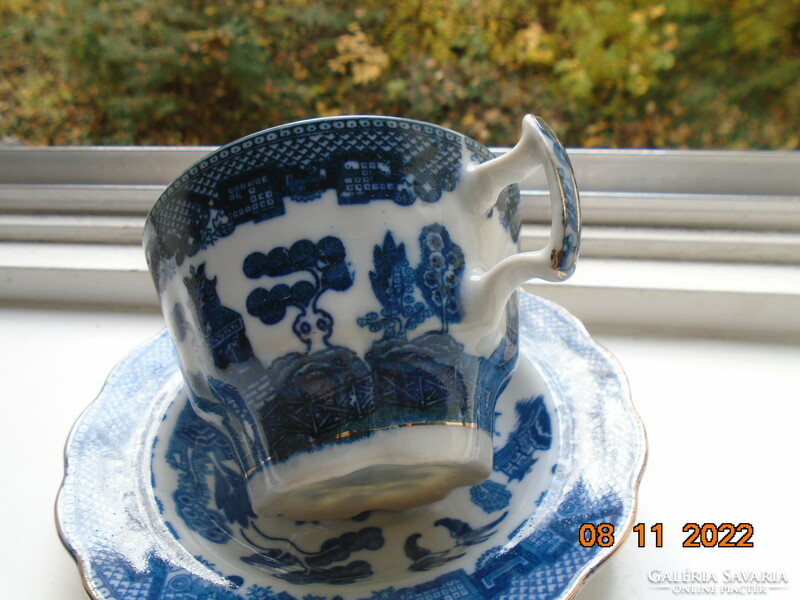 Cobalt blue painted oriental willow pattern English teacup with saucer