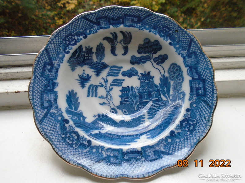 Cobalt blue painted oriental willow pattern English teacup with saucer