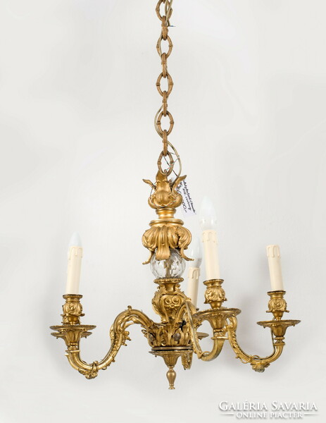 Gilded bronze chandelier with a glass globe in the middle