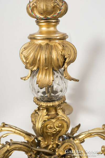 Gilded bronze chandelier with a glass globe in the middle