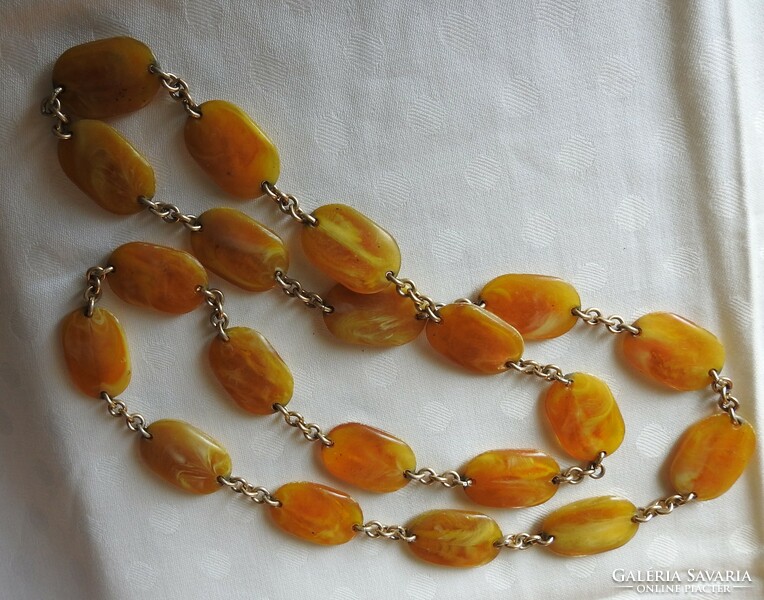 A string of pearls made of amber-looking flat stones - necklace