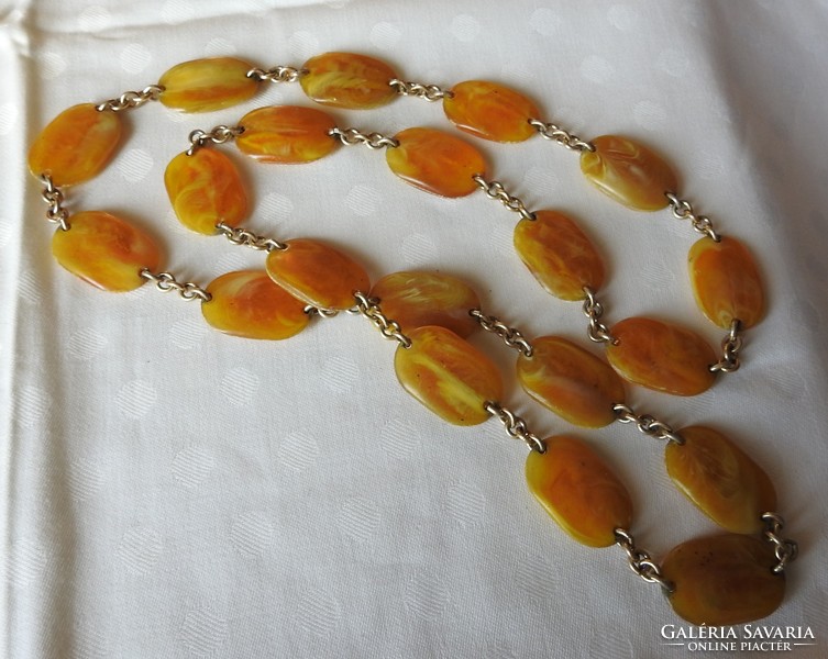 A string of pearls made of amber-looking flat stones - necklace