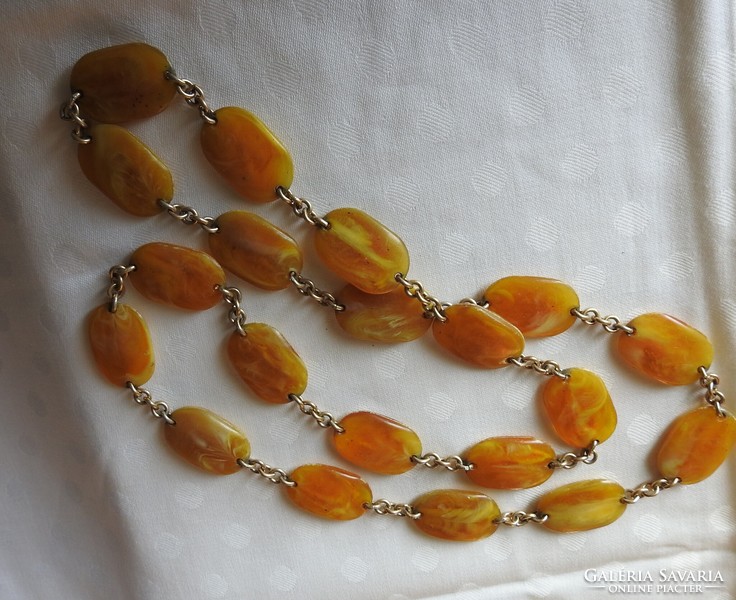 A string of pearls made of amber-looking flat stones - necklace