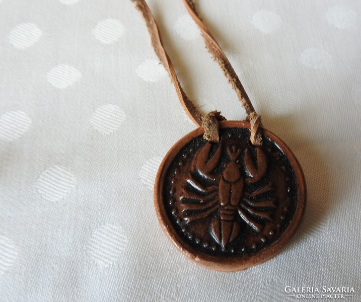 Cancer ceramic pendant on a leather strap