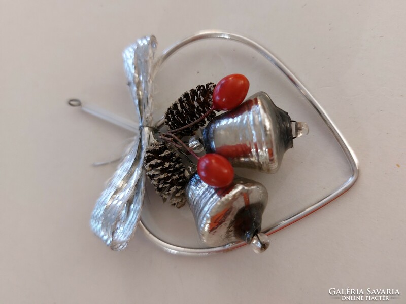 Old glass Christmas tree ornament with a ringing glass ornament in a silver heart