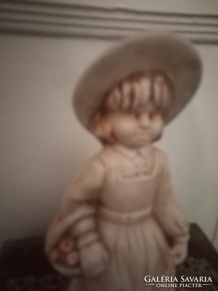 Ceramic statue of a little girl in a hat with a basket of apples