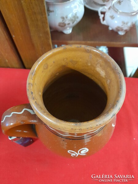 Old ceramic mug, straw, jug, flask.
