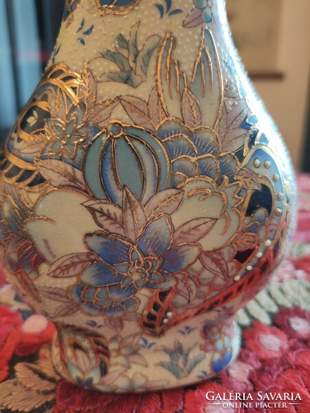 Richly decorated antique Chinese porcelain vase with blue flowers and gold contours