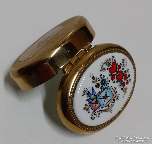A small jewelry box with a porcelain inlay on the gilded chiselled top