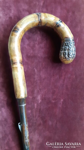Antique wooden umbrella handle with carved decoration.