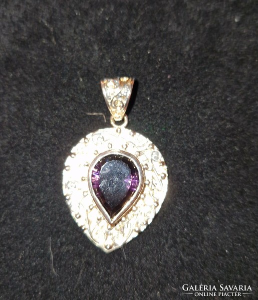 With an extra showy, large amethyst colored stone